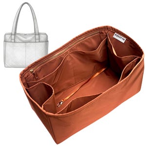 May include: A rust-colored bag organizer insert featuring multiple interior pockets, a zippered compartment, and a small attached strap with a metal clasp. A white fabric label with the black text PZEOTYN is sewn inside. A line drawing of a tote bag is shown.