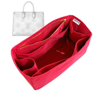 May include: A vibrant red handbag organiser with several compartments and a gold zip. The organiser is designed to fit inside a white tote bag, seen in the background. The label "PZEOTYN" is visible on the organiser.
