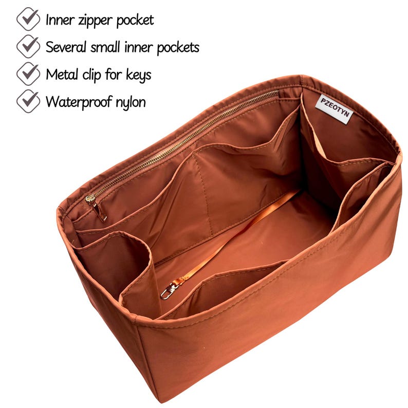 May include: A rust-colored nylon bag organizer with multiple compartments and a metal key clip. Features include an inner zipper pocket and several small inner pockets. The text on the image indicates the organizer is made of waterproof nylon.