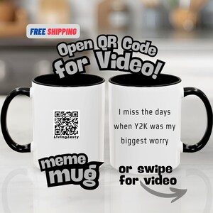May include: White ceramic mug with a black interior, handle, and rim. The mug features the text "I miss the days when Y2K was my biggest worry" and a QR code. The mug also has the text "meme mug".