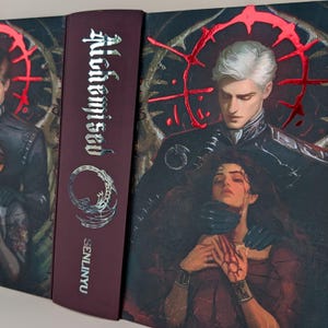 May include: A book with a burgundy spine featuring the title "Alchemised" in silver lettering. The cover art depicts a man and woman in a dark, dramatic scene with red accents. The author's name, SENLINYU, is printed on the spine.