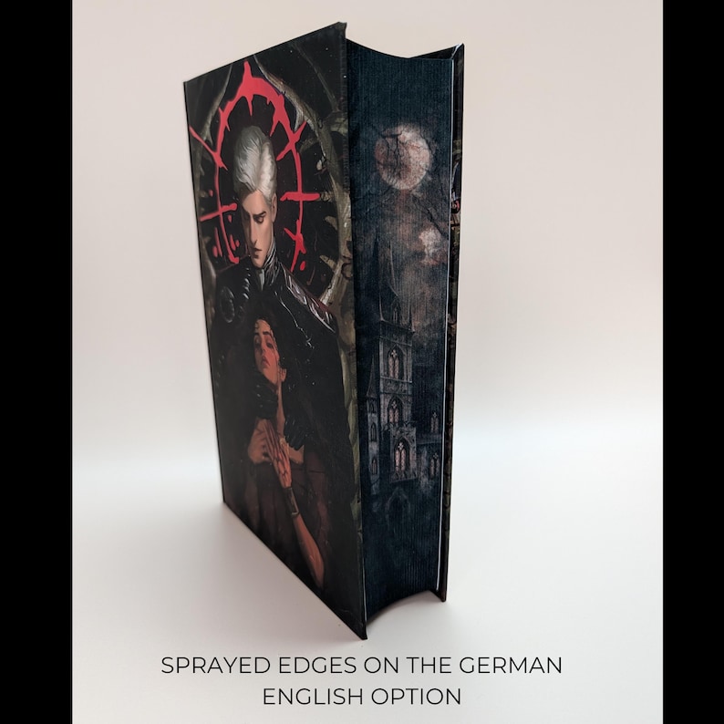 May include: A hardcover book with a dark, gothic-style cover featuring a pale-skinned figure with white hair and a woman. The spine shows a castle under a full moon. The text at the bottom reads "Sprayed edges on the German English option."