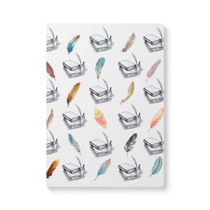 May include: White notebook with a repeating pattern of watercolor feathers and stacks of books with quills. The feathers are in shades of red, orange, yellow, blue, and brown. The books and quills are in black and white.