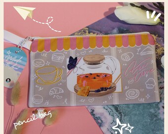 May include: A gray pencil bag with a colorful design featuring a teapot with tea, a butterfly, and the text "Tea Time".