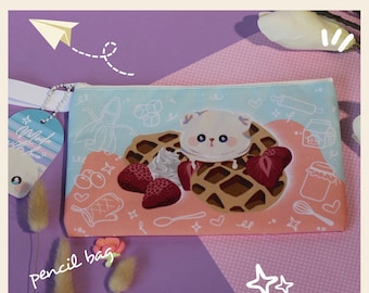 May include: A pink and blue pencil bag with a white cat sitting on a waffle with strawberries and whipped cream. The bag has the text "pencil bag" and a white star on the bottom right corner.