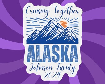 May include: A white sticker with a blue and orange mountain and sun design. The text reads "Cruising together ALASKA Johnson Family 2024" in a mix of fonts. The background is a purple and white swirl pattern.