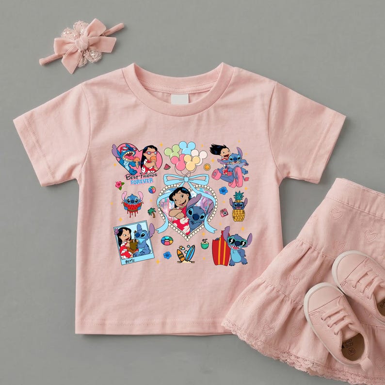 May include: A light pink short-sleeved t-shirt featuring a graphic print of Lilo and Stitch characters, colorful balloons, and the text "BEST FRIENDS FOREVER". The set includes a matching pink headband with a bow and a tiered pink skirt.