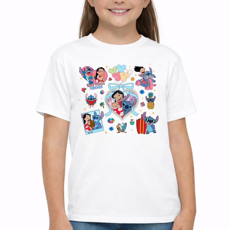 May include: A white short-sleeved t-shirt featuring a colorful graphic print of Lilo and Stitch characters. The design includes multiple illustrations of the pair, a heart-shaped frame with a blue bow, and the text Best Friends Forever.