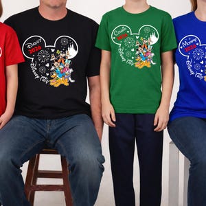 May include: A group of matching t-shirts in red, black, green, and blue. Each shirt features a Mickey Mouse head design with text indicating "Sister 2026", "Daddy 2026", "Cousin", and "Mommy 2026", along with "Disney Trip" text and character graphics.