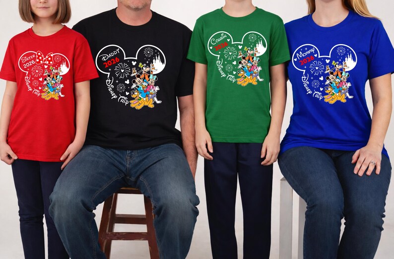 May include: A group of matching t-shirts in red, black, green, and blue. Each shirt features a Mickey Mouse head design with text indicating "Sister 2026", "Daddy 2026", "Cousin", and "Mommy 2026", along with "Disney Trip" text and character graphics.