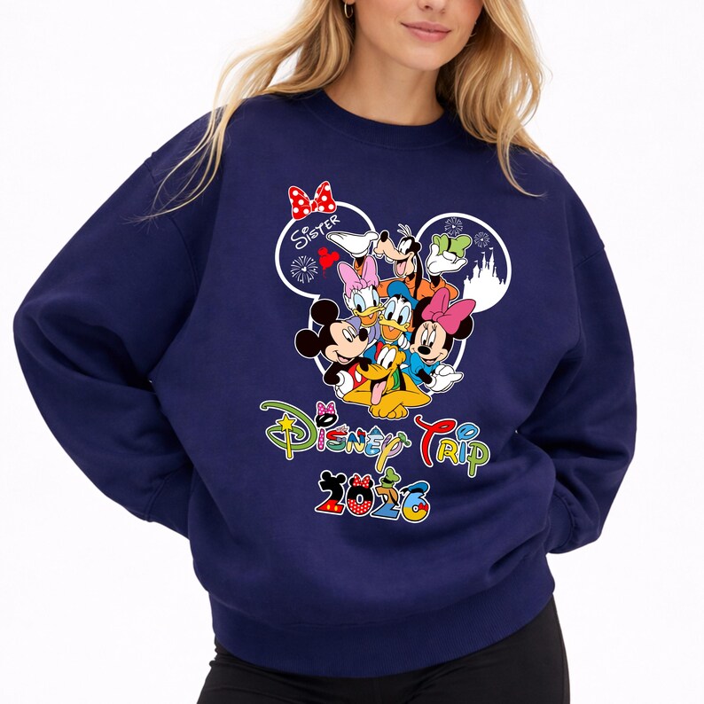 May include: Navy blue sweatshirt with a Disney Trip 2020 design. The graphic features Mickey and Minnie Mouse, Donald and Daisy Duck, Goofy, and Pluto. The word "Sister" is written above the characters in a heart-shaped design.