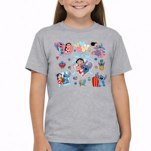 May include: A heather gray short-sleeve t-shirt featuring a colorful graphic print of Lilo and Stitch characters. The design includes various illustrations of the pair, a heart-shaped frame with a blue bow, balloons, and the text Best Friends Forever.