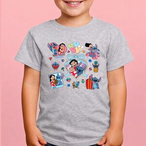 May include: A heather gray short-sleeve t-shirt featuring a colorful graphic print of Lilo and Stitch characters. The design includes multiple illustrations of the pair, a heart-shaped frame, balloons, surfboards, and the text Best Friends Forever.