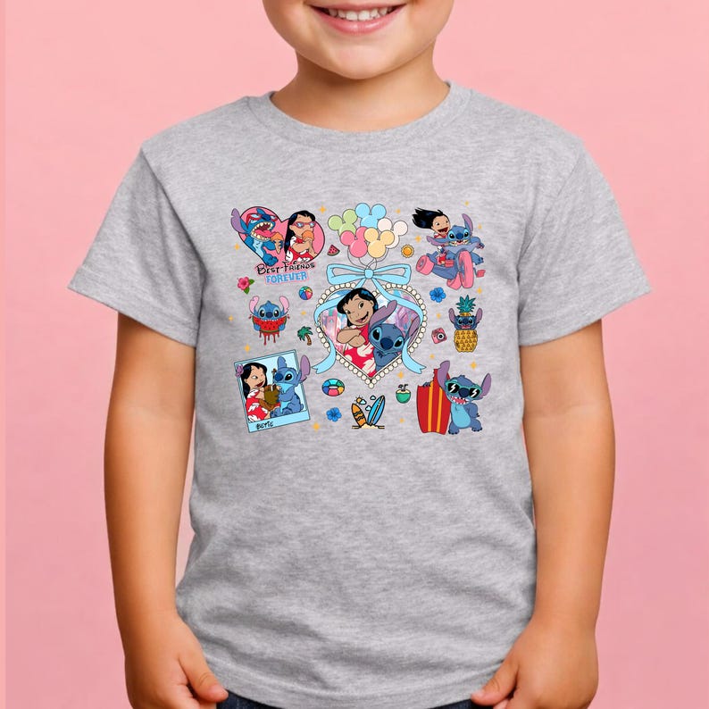 May include: A heather gray short-sleeve t-shirt featuring a colorful graphic print of Lilo and Stitch characters. The design includes multiple illustrations of the pair, a heart-shaped frame, balloons, surfboards, and the text Best Friends Forever.