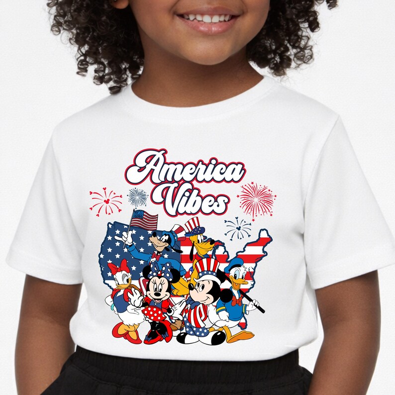 May include: White t-shirt featuring the text "America Vibes" with cartoon characters in patriotic attire. The design includes fireworks, a map of the United States, and the American flag. A fun and festive design for Independence Day.