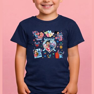 May include: A navy blue short-sleeve t-shirt featuring a colorful graphic print of Lilo and Stitch characters. The design includes multiple small illustrations, a central heart-shaped frame with a bow, and the text Best Friends Forever.