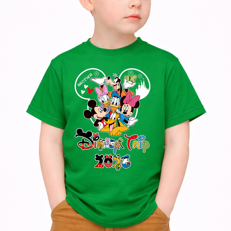 May include: Green t-shirt with a Disney character graphic, including Mickey and Minnie Mouse, Donald Duck, and Goofy. The text "Disney Trip 2020" is displayed in a colourful font on the shirt.