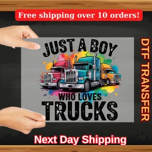 May include: A gray t-shirt design with a colorful graphic of three semi-trucks and the text "Just a boy who loves trucks".