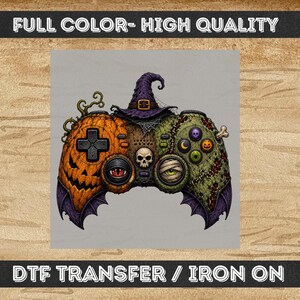 May include: A DTF transfer iron-on featuring a video game controller design with a pumpkin-themed left side, a mummy-themed right side, a purple witch hat on top, a central skull, and bat-wing accents. The text reads FULL COLOR- HIGH QUALITY and DTF TRANSFER / IRON ON.