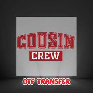 May include: A red and white graphic design on a gray background. The text "COUSIN" is arched above the word "CREW" in a rectangular box. The words "DTF TRANSFER" are at the bottom in red.