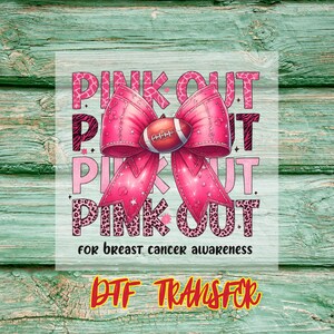 May include: A pink and white graphic with the words "PINK OUT" repeated multiple times, a large pink bow and a football. The text "for breast cancer awareness" is included. The words "DTF TRANSFER" are at the bottom.