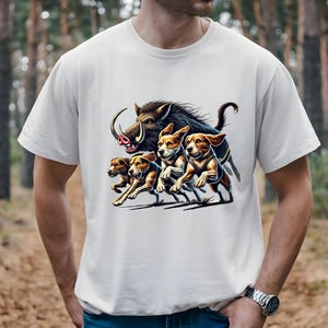 May include: A white t-shirt with a graphic print of a wild boar being chased by four beagles. The boar is brown and black with a long snout and tusks. The beagles are brown and white with floppy ears.