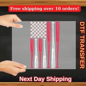 May include: A gray DTF transfer sheet featuring a baseball-themed American flag design. The flag's stars are replaced with baseballs, and the stripes are represented by red and white baseball bats. The text "Next Day Shipping" is at the bottom.