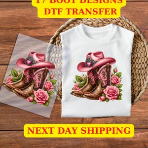 May include: A white t-shirt with a pink cowboy hat and boots with roses. The design is on a clear sheet of transfer paper.