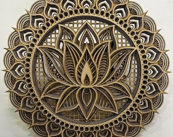 May include: A wooden mandala with a lotus flower design. The mandala is made of multiple layers of wood, creating a 3D effect. The lotus flower is in the center of the mandala and is surrounded by a circular pattern.