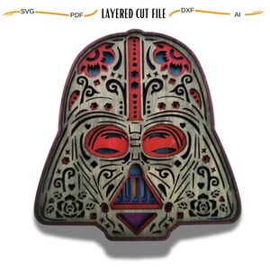 May include: A wooden cutout of Darth Vader's helmet in the style of a Day of the Dead sugar skull. The helmet is decorated with intricate floral patterns and colorful accents.