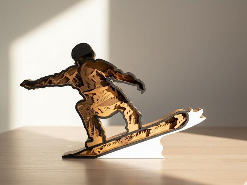 May include: A wooden sculpture of a snowboarder in motion. The figure is made of layered wood, with a black outline and a natural wood color for the body and snowboard. The base is white.