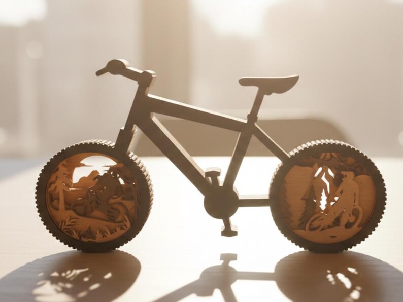 May include: A wooden bicycle sculpture with intricate cut-out designs in the wheels, depicting a mountain biking scene. The bicycle is brown and has a detailed frame, handlebars, seat, and pedals. The wheels feature a detailed forest scene.