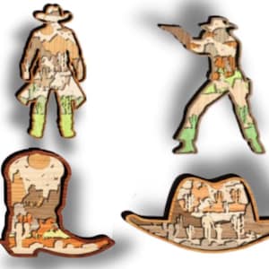 May include: Four wooden laser cut ornaments featuring a cowboy, a cowgirl, a cowboy boot, and a cowboy hat. Each ornament is decorated with a detailed landscape design.