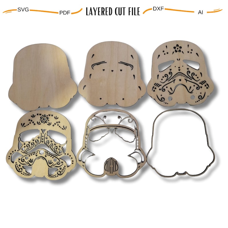 May include: Six layered wooden cutouts of a Star Wars Stormtrooper helmet with a Day of the Dead sugar skull design. The cutouts are in various stages of completion, from a basic outline to a fully detailed design.