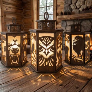 May include: Three wooden lanterns with animal cutouts: a bear, an owl, and a lion. The lanterns are illuminated from within, casting light through the animal designs. The lanterns are on a wooden surface.