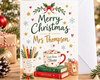 May include: A white Christmas greeting card featuring the text Merry Christmas Mrs Thompson. The design includes a mug of hot cocoa labeled Love from Oliver, a pencil holder with the text Kind Teachers Change Brighter Futures, and two books labeled Teach and Inspire.