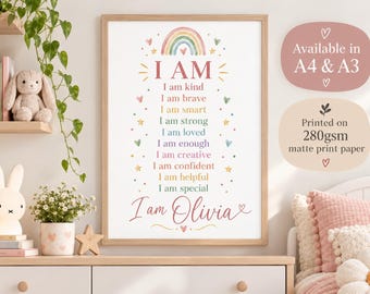 May include: A framed wall art print featuring a rainbow and the text I AM followed by a list of positive affirmations including I am kind, brave, smart, strong, loved, enough, creative, confident, helpful, and special, ending with I am Olivia.