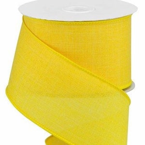May include: A spool of bright yellow wired ribbon. The ribbon is made of a soft, textured fabric and is perfect for adding a pop of color to any craft project.