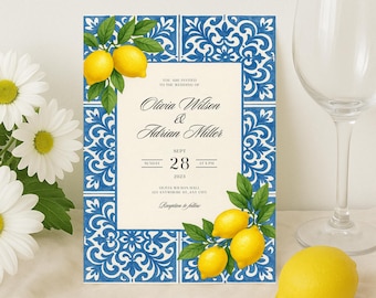 May include: Wedding invitation with a blue and white tile design, featuring lemons and green leaves. The invitation includes the names Olivia Wilson & Adrian Miller, date, time, and venue details. A wine glass and daisies are in the background.