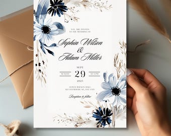 May include: A wedding invitation with a watercolor floral design in shades of blue and brown. The invitation features the names "Sophia Wilson & Adam Miller" and the date "Sept 29, 2025".
