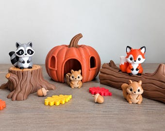 May include: A set of small plastic animal figurines including a raccoon, a fox, and two squirrels, accompanied by a hollow orange pumpkin, a brown tree stump, a brown log, and several small colorful leaf and acorn shaped accessories.