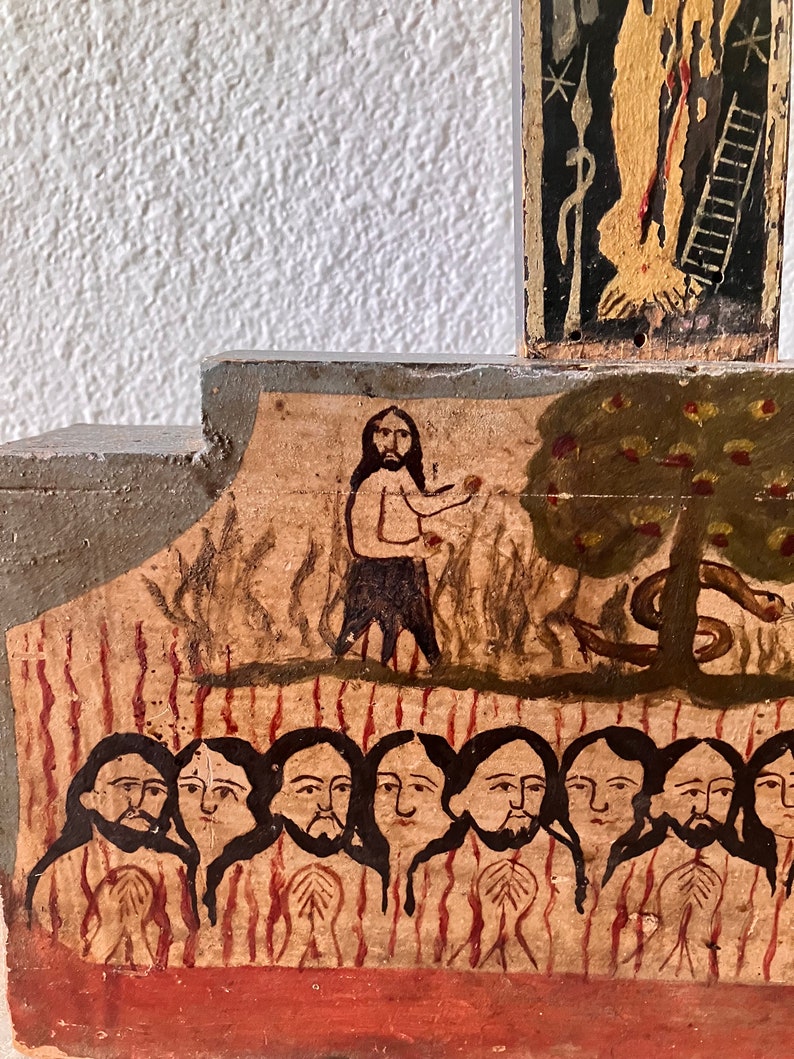 May include: A section of a painted wooden religious icon depicting biblical scenes. The artwork features figures with long hair and beards, a tree with apples, and a serpent. The color palette includes earth tones, red, and black.