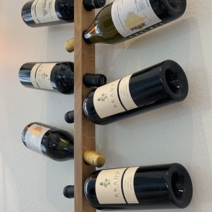 This Viking Longship (langskib) inspired wine rack brings the essence of a journey into your home or office. Each bottle angled downward, wine stays in contact with the cork. 8 ports wine bottles which allow opposing storage of four bottles per side.