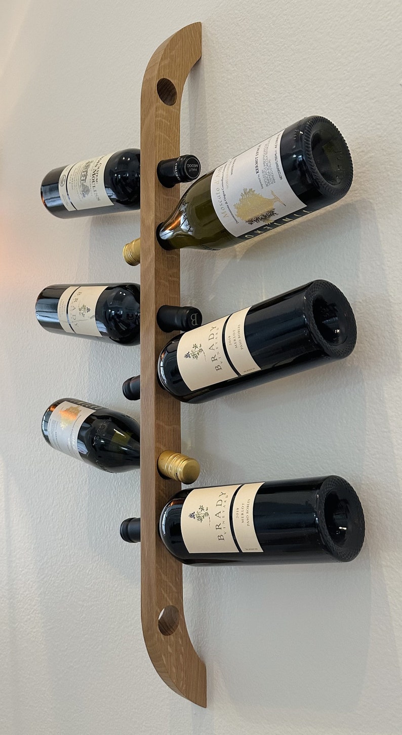 This Viking Longship (langskib) inspired wine rack brings the essence of a journey into your home or office. Each bottle angled downward, wine stays in contact with the cork. 8 ports wine bottles which allow opposing storage of four bottles per side.