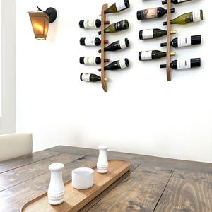This Viking Longship (langskib) inspired wine rack brings the essence of a journey into your home or office. Each bottle angled downward, wine stays in contact with the cork. 8 ports wine bottles which allow opposing storage of four bottles per side.
