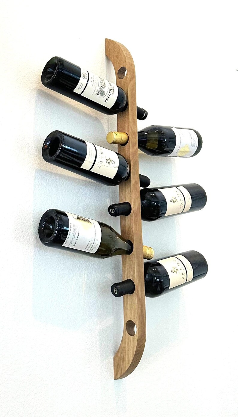 This Viking Longship (langskib) inspired wine rack brings the essence of a journey into your home or office. Each bottle angled downward, wine stays in contact with the cork. 8 ports wine bottles which allow opposing storage of four bottles per side.