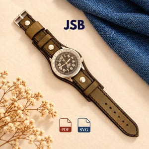 May include: A wristwatch with a round silver-tone case, a black dial featuring white numerals, and a wide olive green leather cuff strap secured with silver-tone metal rivets and a buckle. The text JSB is visible above the watch, with PDF and SVG icons below.