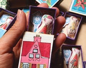 Miniture Camille pocket doll in her little matchbox home