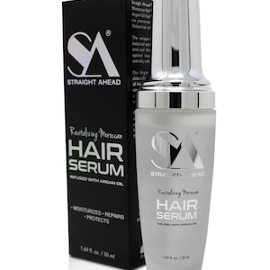 May include: A white and silver hair serum bottle and black box. The bottle and box both feature the text "STRAIGHT AHEAD" and "Revitalizing Moroccan HAIR SERUM INFUSED WITH ARGAN OIL". The bottle is 1.69 fl. oz. / 50 ml.