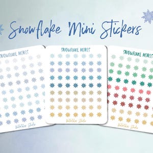 May include: Three sets of Snowflake Mini Stickers in various color palettes. Each set features a grid of snowflake designs in shades of blue, teal, gold, green, and red. The text "Snowflake Mini Stickers" is written in cursive above the stickers.